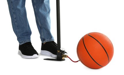 Photo of Man inflating basketball ball with manual air pump on white background, closeup
