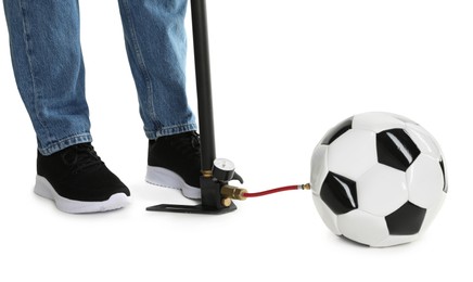 Photo of Man inflating soccer ball with manual air pump on white background, closeup