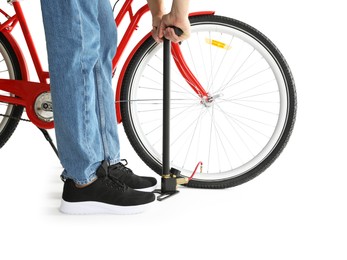 Photo of Man inflating bicycle tire with manual air pump on white background, closeup