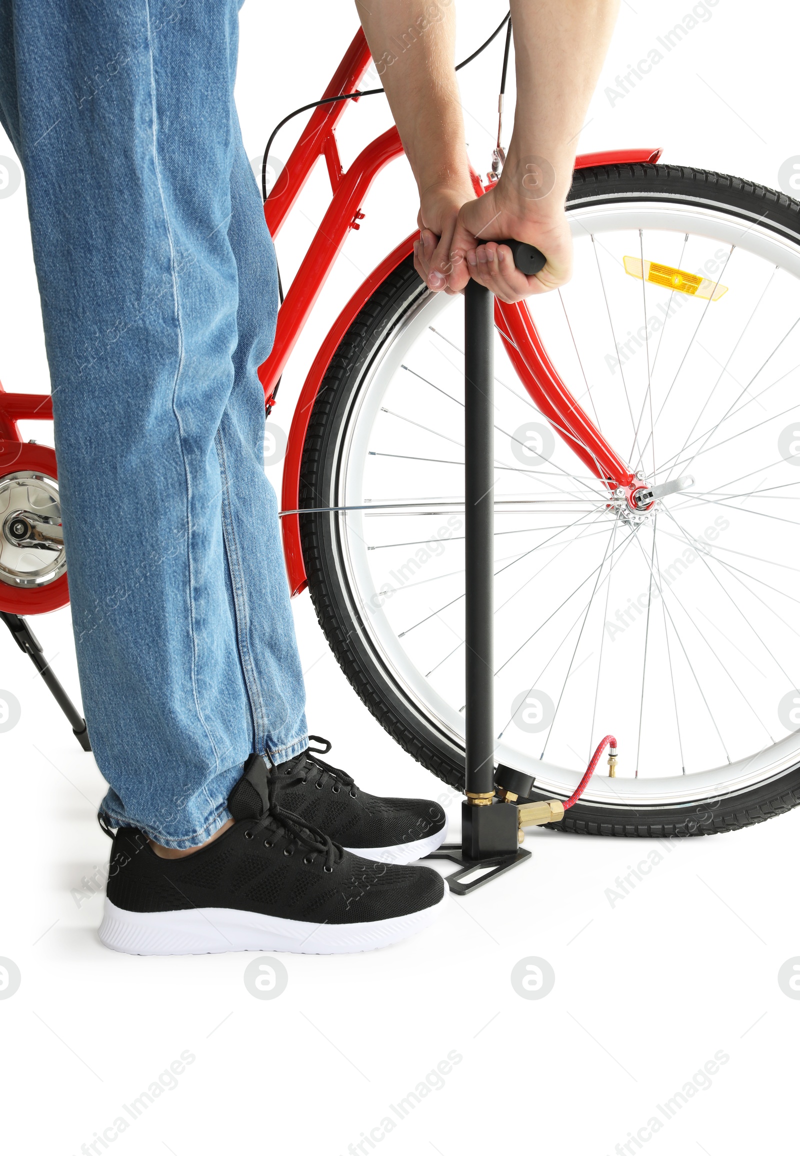 Photo of Man inflating bicycle tire with manual air pump on white background, closeup