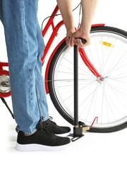 Photo of Man inflating bicycle tire with manual air pump on white background, closeup