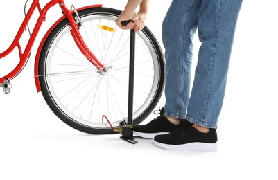 Photo of Man inflating bicycle tire with manual air pump on white background, closeup
