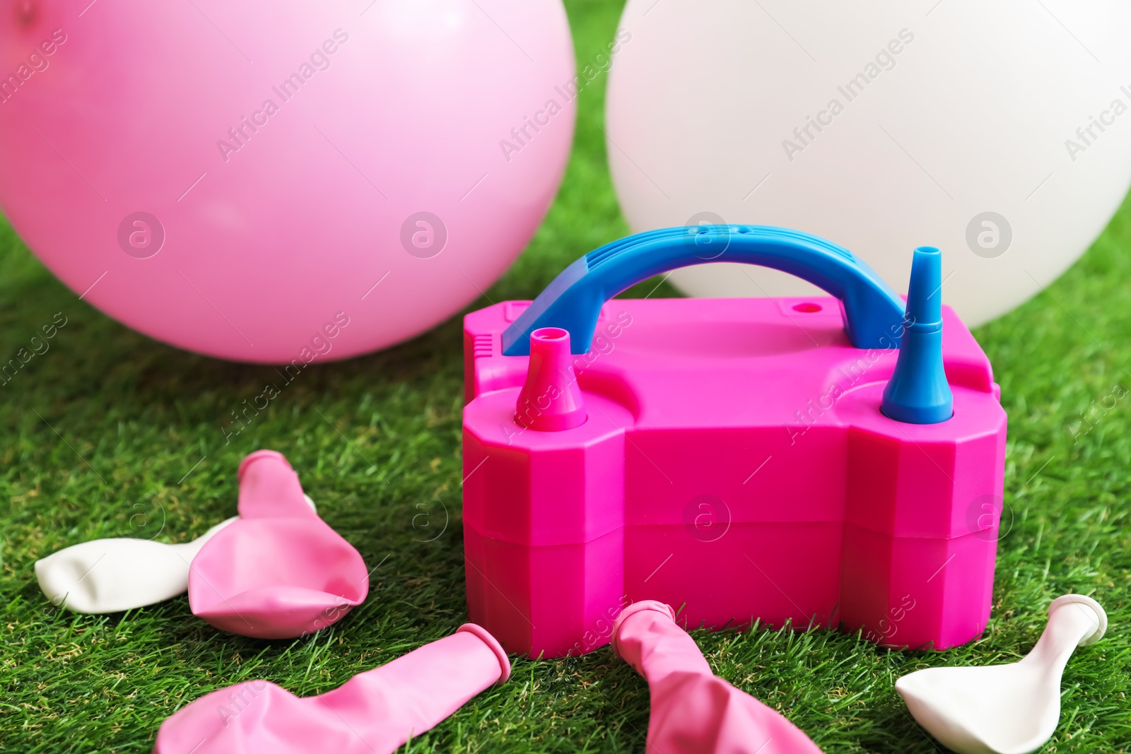 Balloons and air pump indoors, closeup view Photo of Balloons and air pump indoors, closeup view