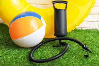 Photo of Ball, inflatable ring and manual air pump indoors