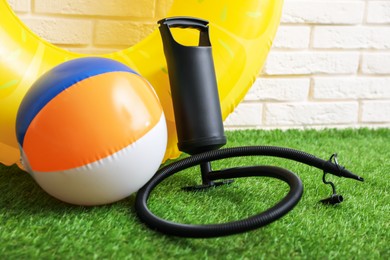 Photo of Ball, inflatable ring and manual air pump indoors