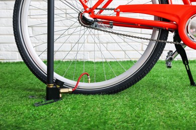 Photo of Bicycle and manual air pump indoors, closeup