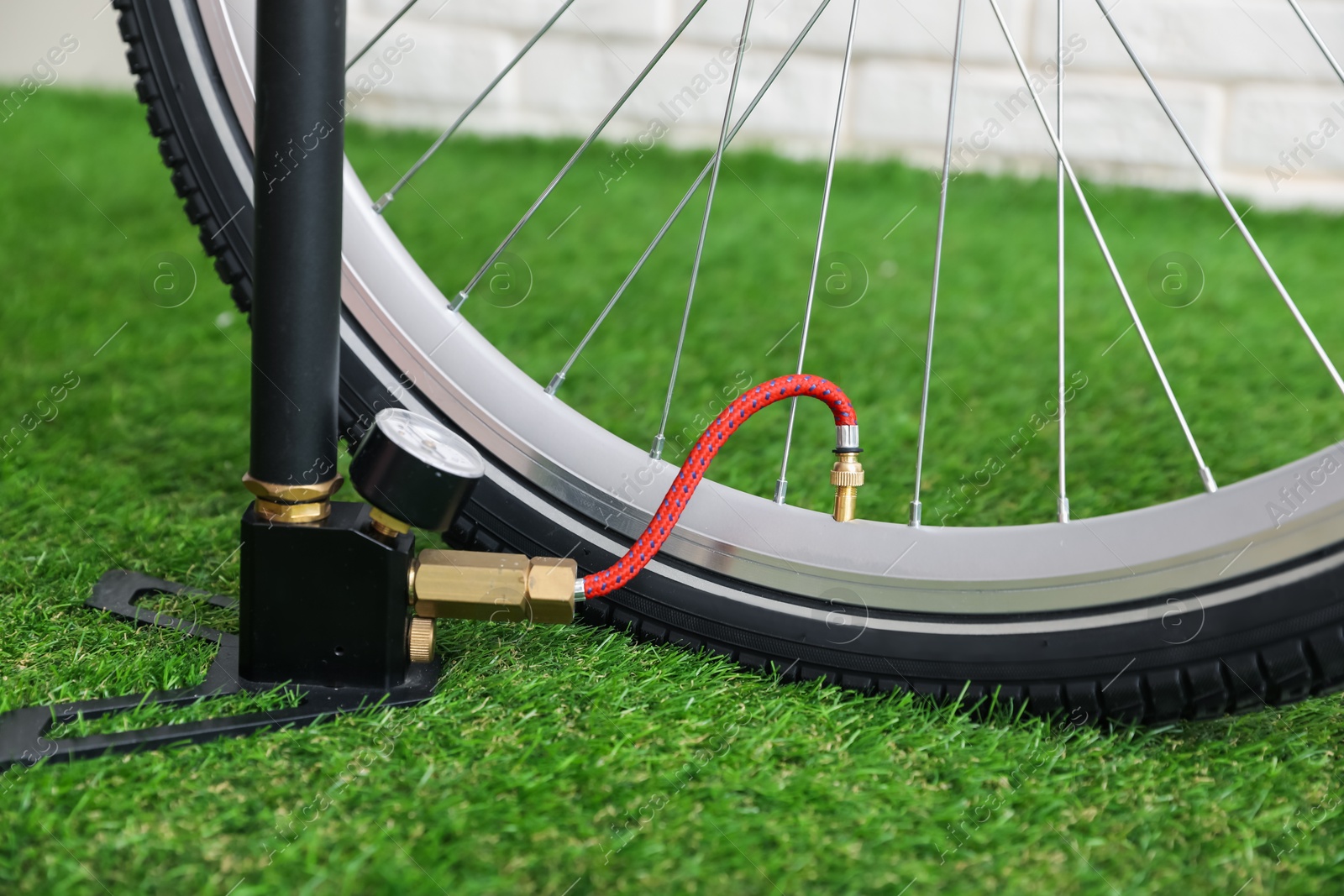 Bicycle and manual air pump indoors, closeup Photo of Bicycle and manual air pump indoors, closeup