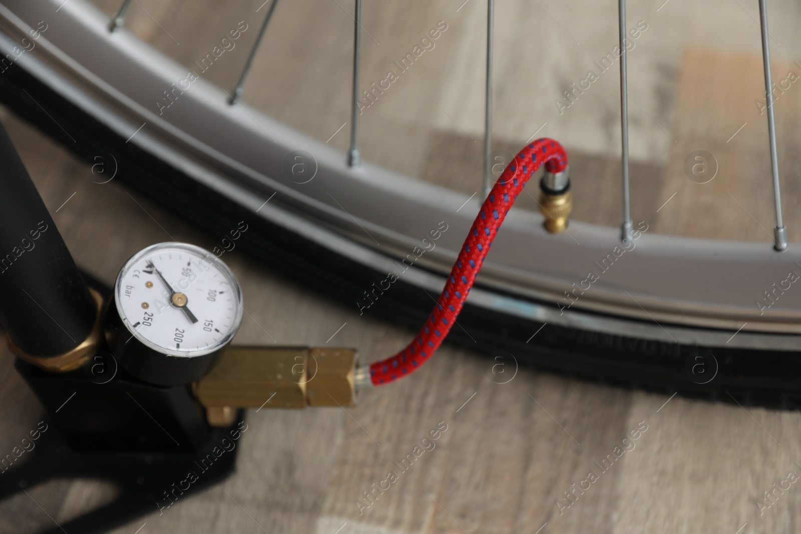 Bicycle and manual air pump indoors, closeup Photo of Bicycle and manual air pump indoors, closeup