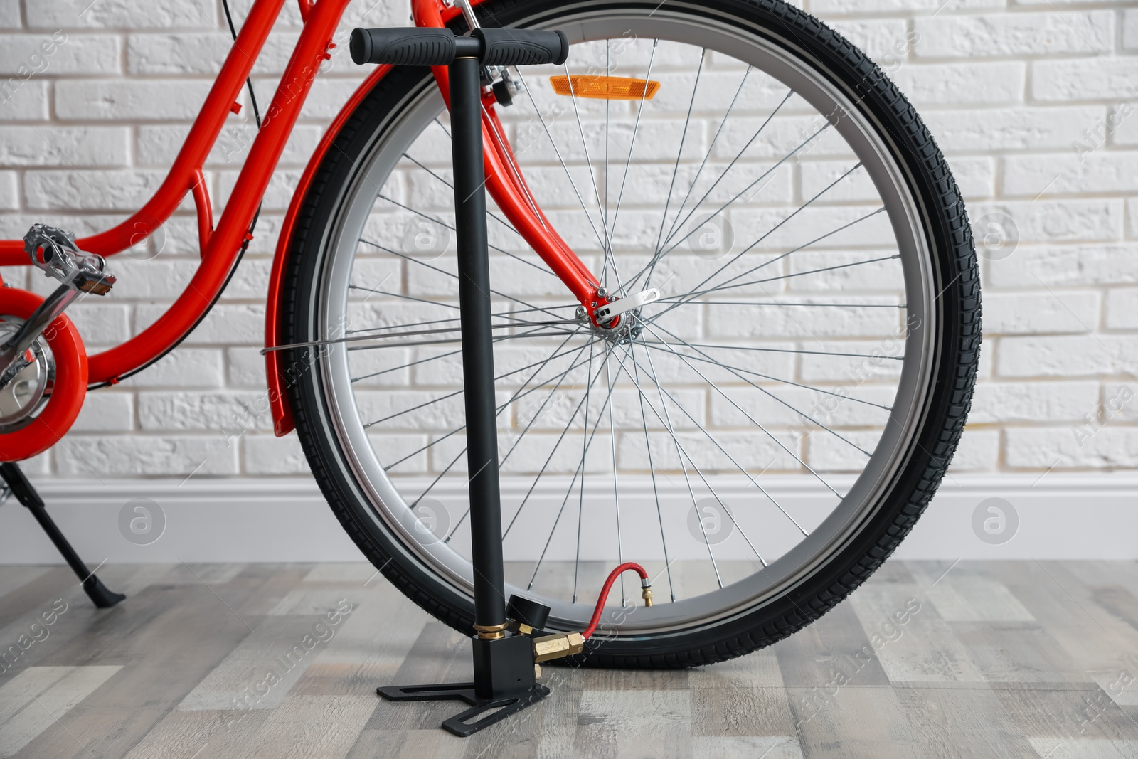 Bicycle and manual air pump indoors, closeup Photo of Bicycle and manual air pump indoors, closeup