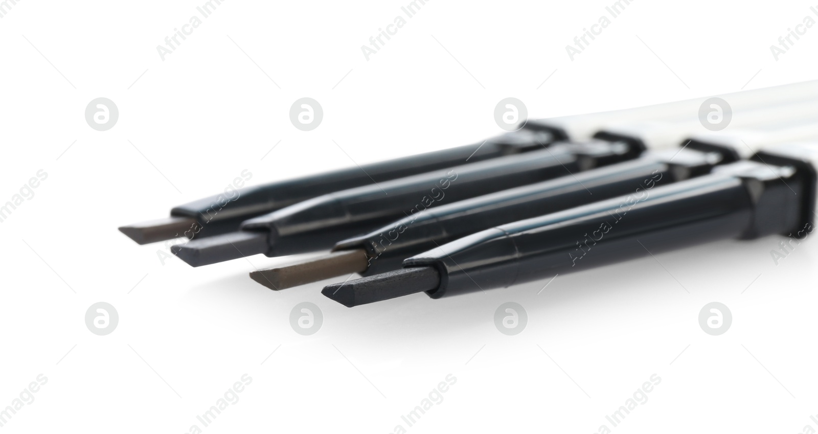 Photo of Many twist up eyebrow pencils isolated on white