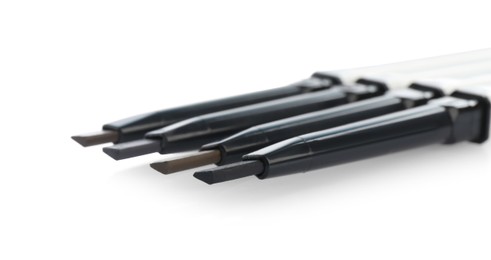 Photo of Many twist up eyebrow pencils isolated on white