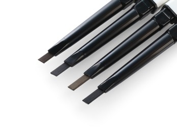 Photo of Many twist up eyebrow pencils isolated on white