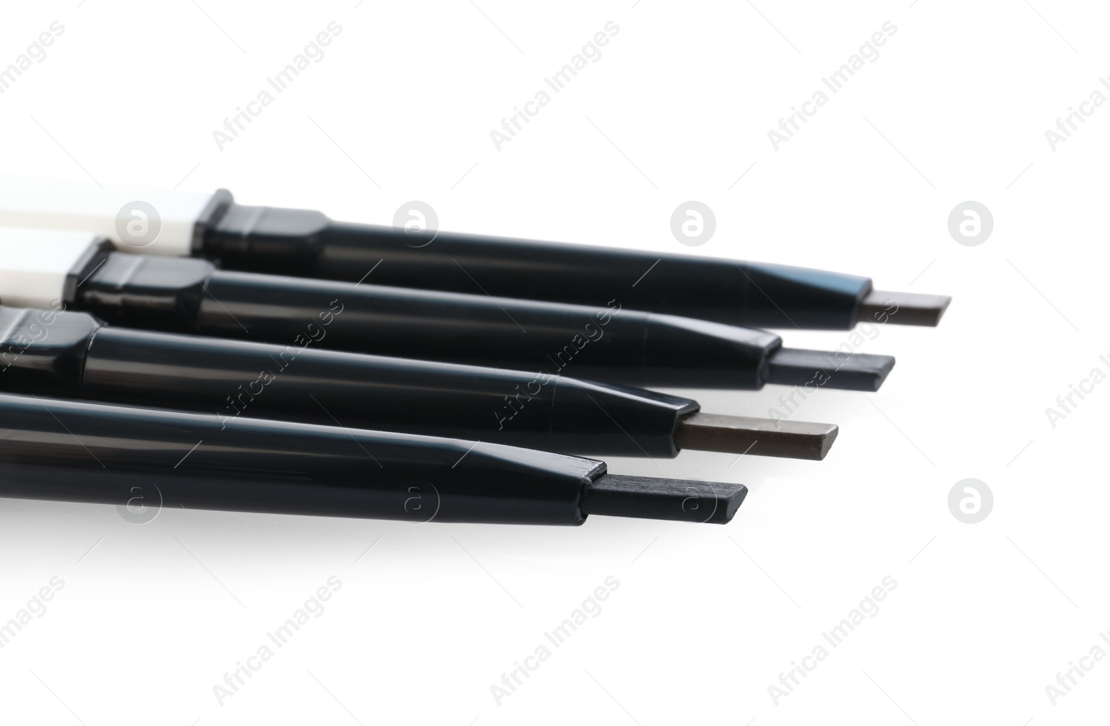 Photo of Many twist up eyebrow pencils isolated on white