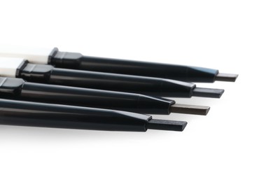 Photo of Many twist up eyebrow pencils isolated on white
