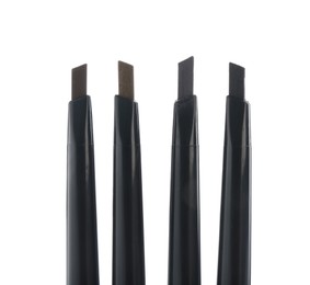 Photo of Many twist up eyebrow pencils isolated on white, top view