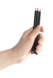 Photo of Woman with eyebrow pencils on white background, closeup