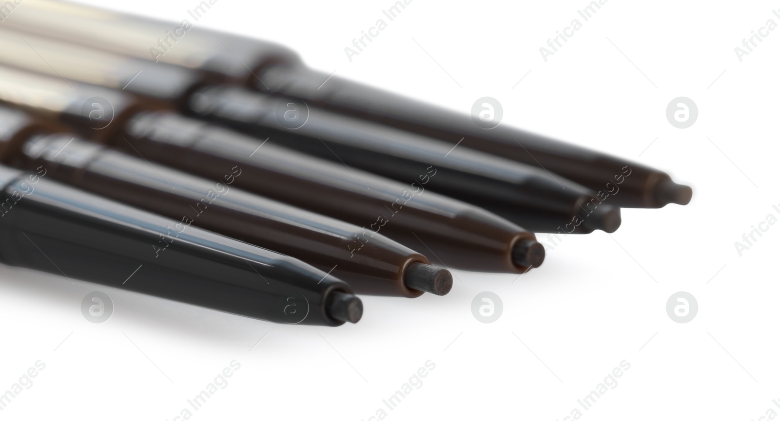 Twist up eyebrow pencils isolated on white Photo of Twist up eyebrow pencils isolated on white