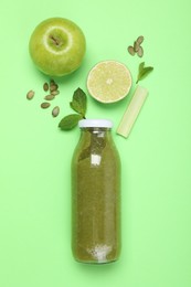 Photo of Superfood. Tasty smoothie in glass bottle and ingredients on green background, flat lay
