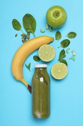 Photo of Superfood. Tasty smoothie in glass bottle and ingredients on light blue background, flat lay