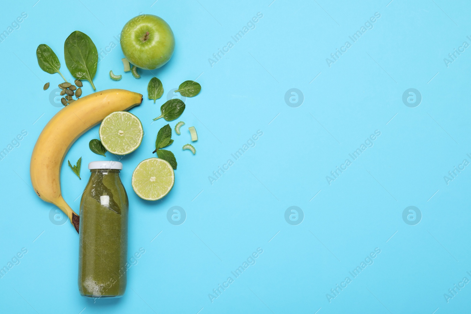 Superfood. Tasty smoothie in glass bottle and ingredients on light blue background, flat lay. Space for text Photo of Superfood. Tasty smoothie in glass bottle and ingredients on light blue background, flat lay. Space for text