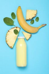 Photo of Superfood. Tasty smoothie in glass bottle and ingredients on light blue background, flat lay
