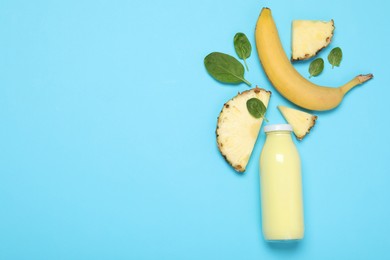 Photo of Superfood. Tasty smoothie in glass bottle and ingredients on light blue background, flat lay. Space for text