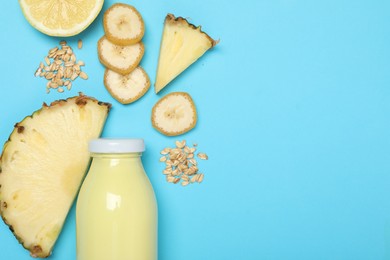 Photo of Superfood. Tasty smoothie in glass bottle and ingredients on light blue background, flat lay. Space for text
