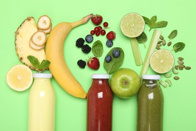 Photo of Superfood. Tasty smoothies in glass bottles and ingredients on green background, flat lay