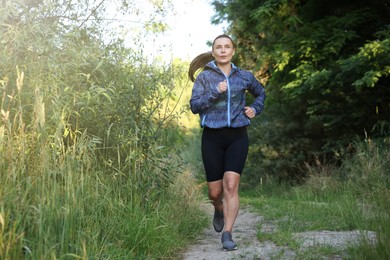 Photo of Beautiful woman in sportswear running in forest