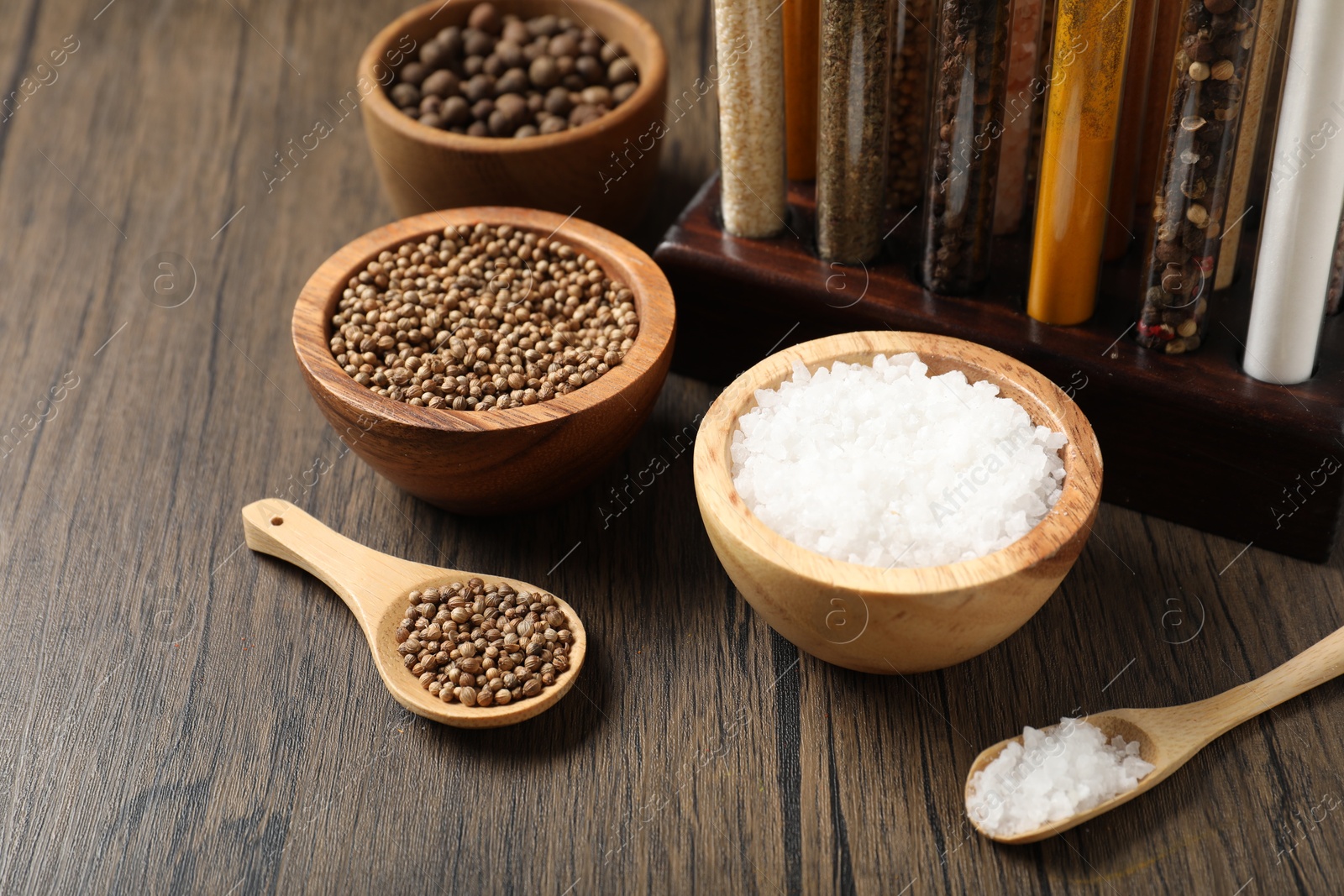Photo of Different aromatic spices on wooden table, closeup