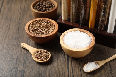 Photo of Different aromatic spices on wooden table, closeup