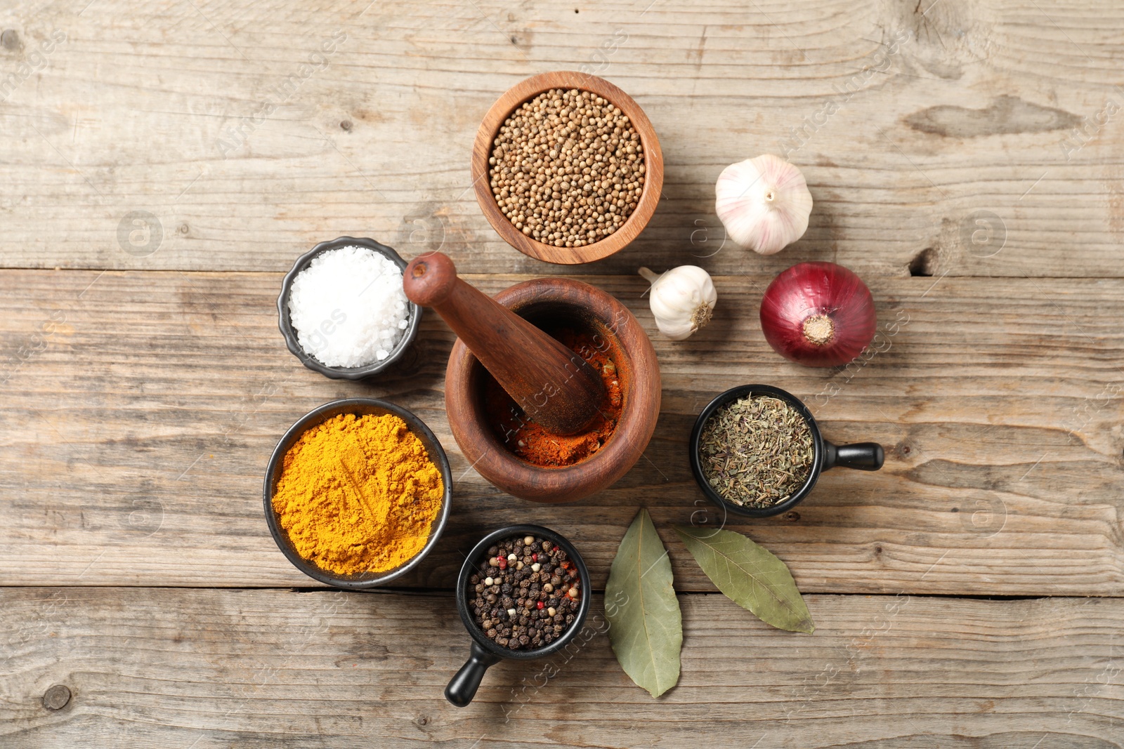 Photo of Different aromatic spices on wooden table, flat lay