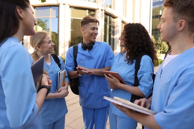Photo of Group of medical students in uniforms near building outdoors