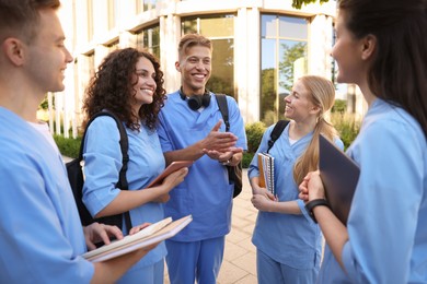 Photo of Group of medical students in uniforms near building outdoors