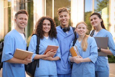 Photo of Group of medical students in uniforms near building outdoors