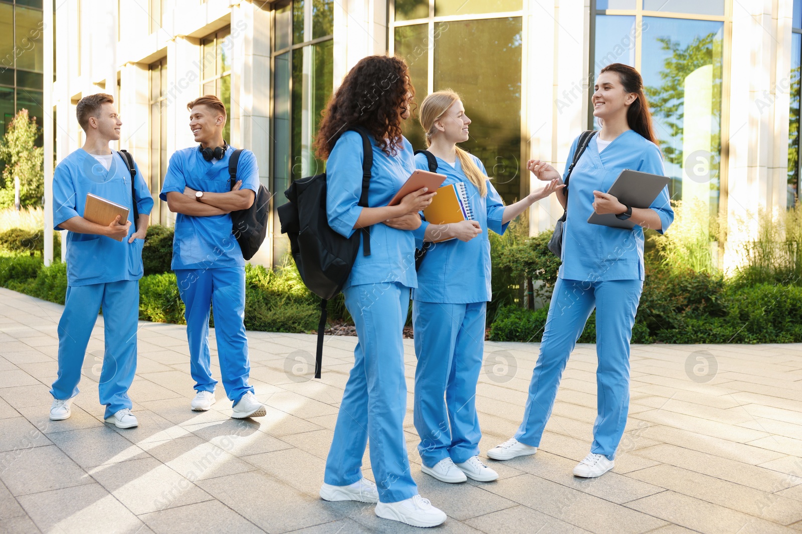 Group of medical students in uniforms near building outdoors Photo of Group of medical students in uniforms near building outdoors
