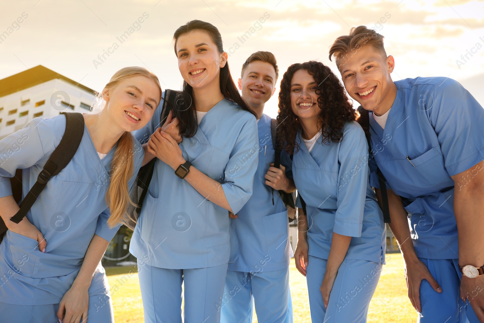 Photo of Group of medical students in uniforms with backpacks outdoors, low angle view