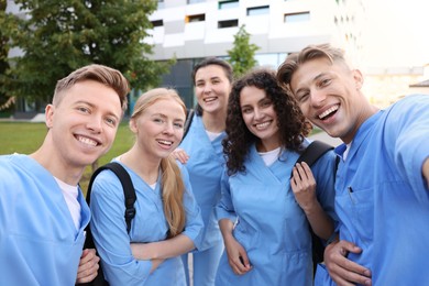 Photo of Group of medical students taking selfie outdoors