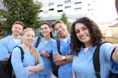 Photo of Group of medical students taking selfie outdoors