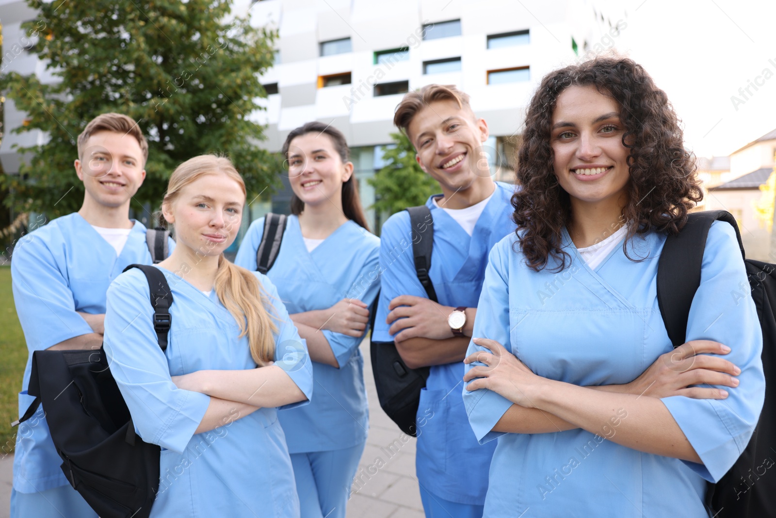 Group of medical students with backpacks outdoors Photo of Group of medical students with backpacks outdoors