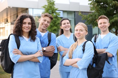 Photo of Group of medical students with backpacks outdoors