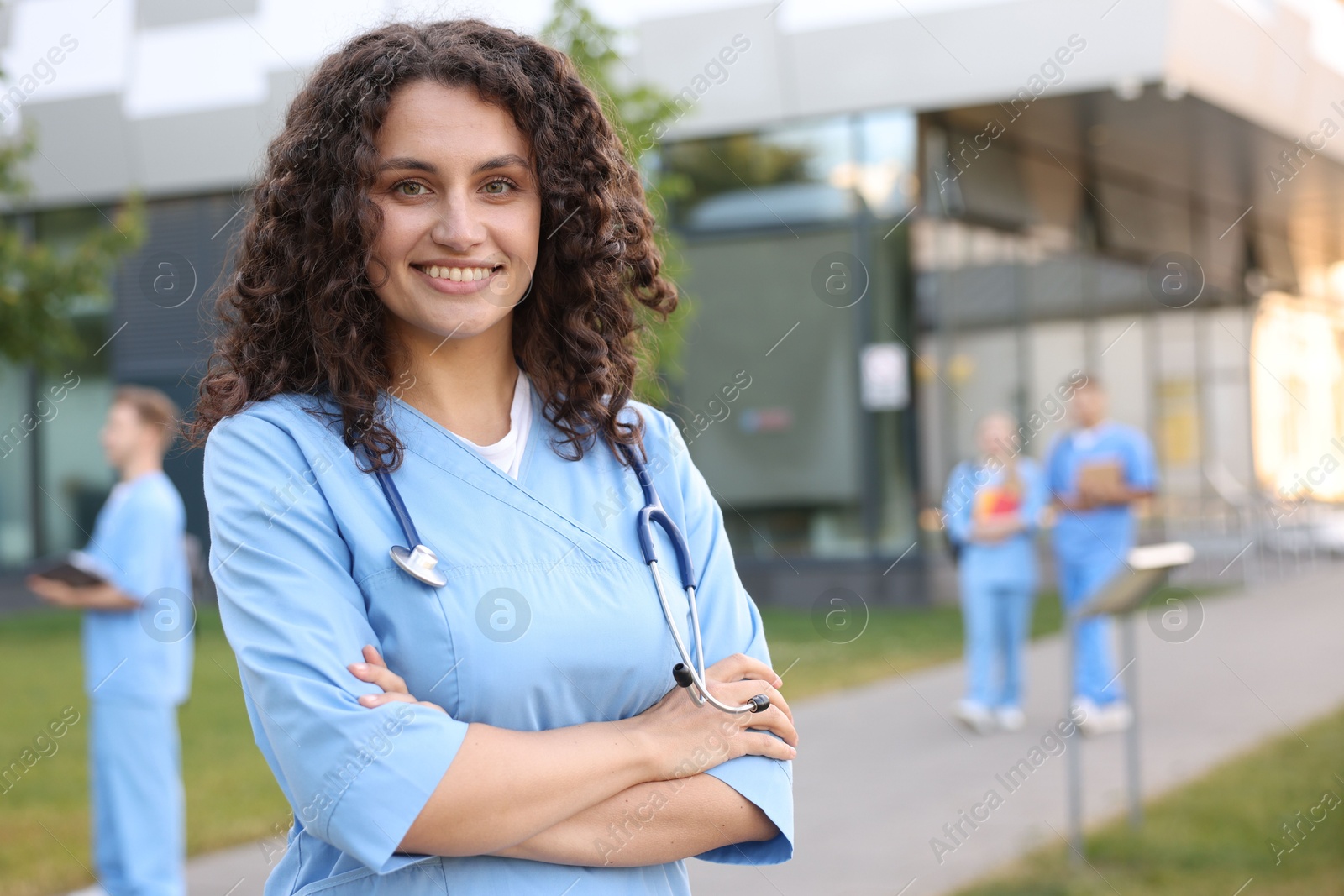 Medical student in uniform with stethoscope outdoors, selective focus Photo of Medical student in uniform with stethoscope outdoors, selective focus
