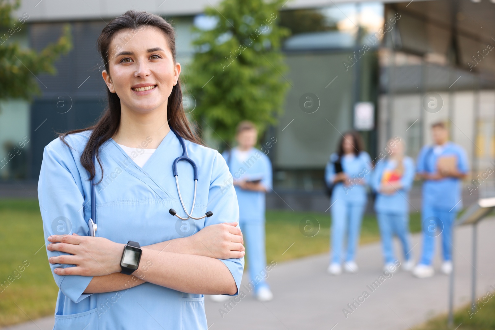 Medical student in uniform with stethoscope outdoors, selective focus Photo of Medical student in uniform with stethoscope outdoors, selective focus