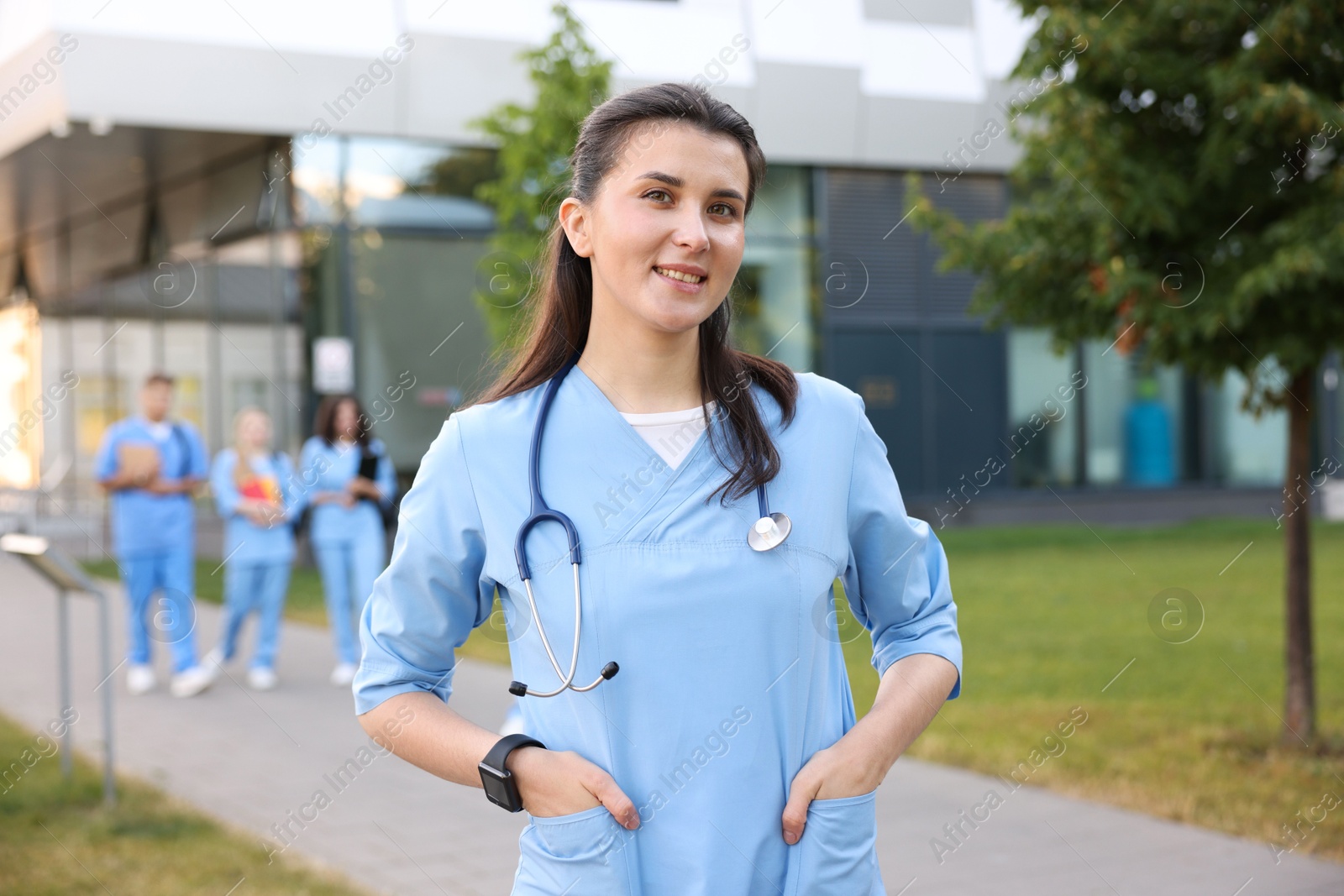 Medical student in uniform with stethoscope outdoors, selective focus Photo of Medical student in uniform with stethoscope outdoors, selective focus