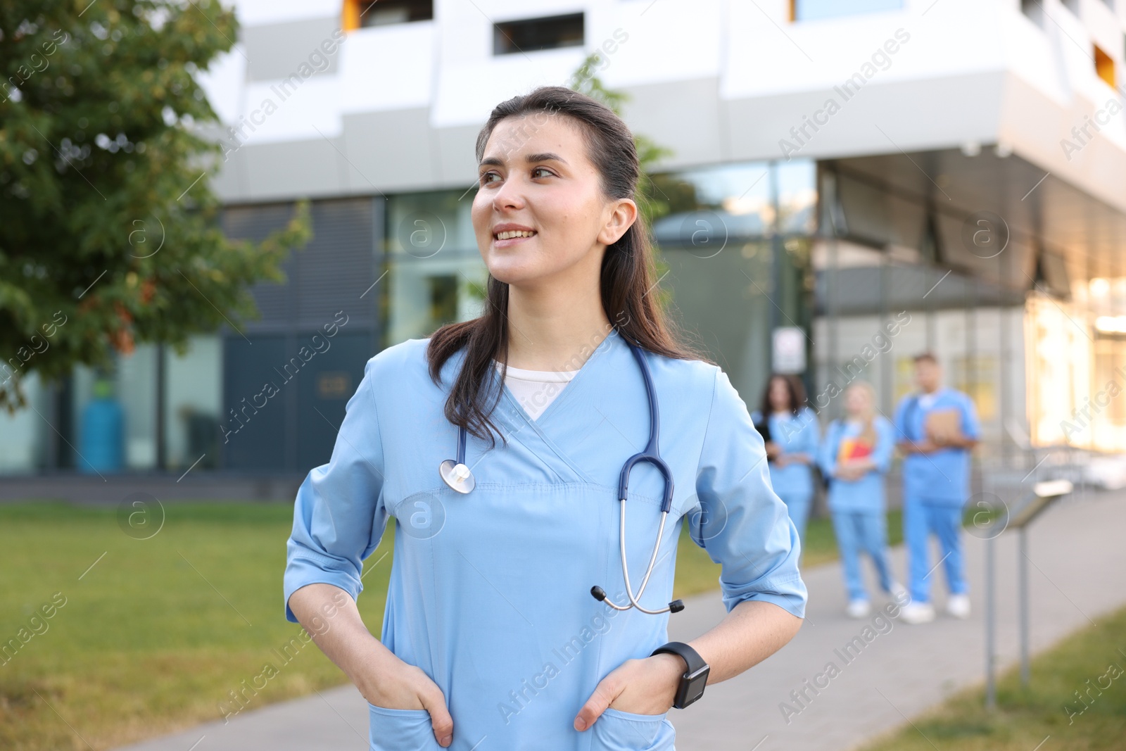 Medical student in uniform with stethoscope outdoors, selective focus Photo of Medical student in uniform with stethoscope outdoors, selective focus
