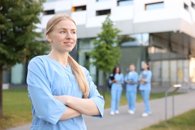 Photo of Medical student in uniform outdoors, selective focus