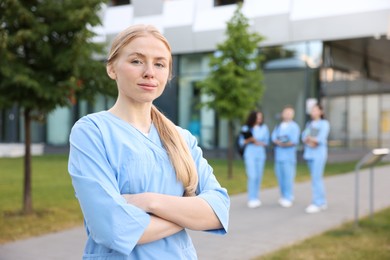 Photo of Medical student in uniform outdoors, selective focus