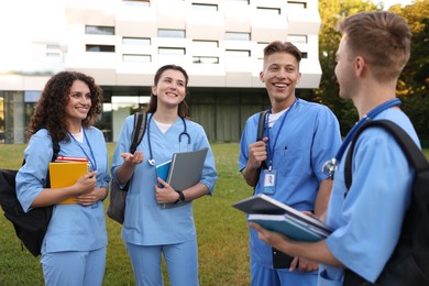 Photo of Group of medical students in uniforms near building outdoors