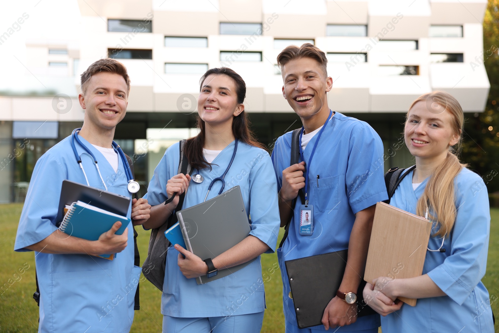 Group of medical students in uniforms near building outdoors Photo of Group of medical students in uniforms near building outdoors