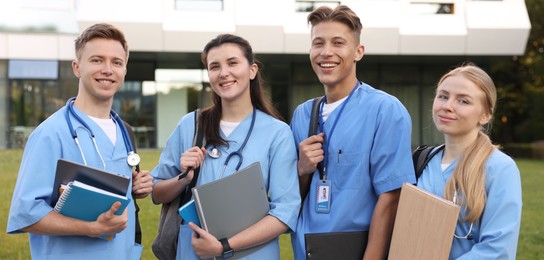 Photo of Group of medical students in uniforms near building outdoors